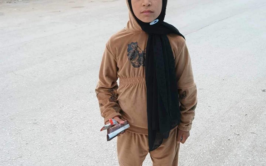 Nine year old girl selling biscuits on the street